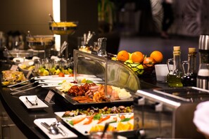 A buffet with various food items and condiments.