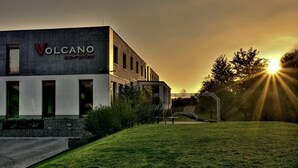 A building named 'Volcano Complex' with a modern architectural style, featuring a flat roof and large windows.