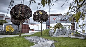 A modern building with a sign reading "Volcano Complex". - Volcano Spa Hotel (Prague)
