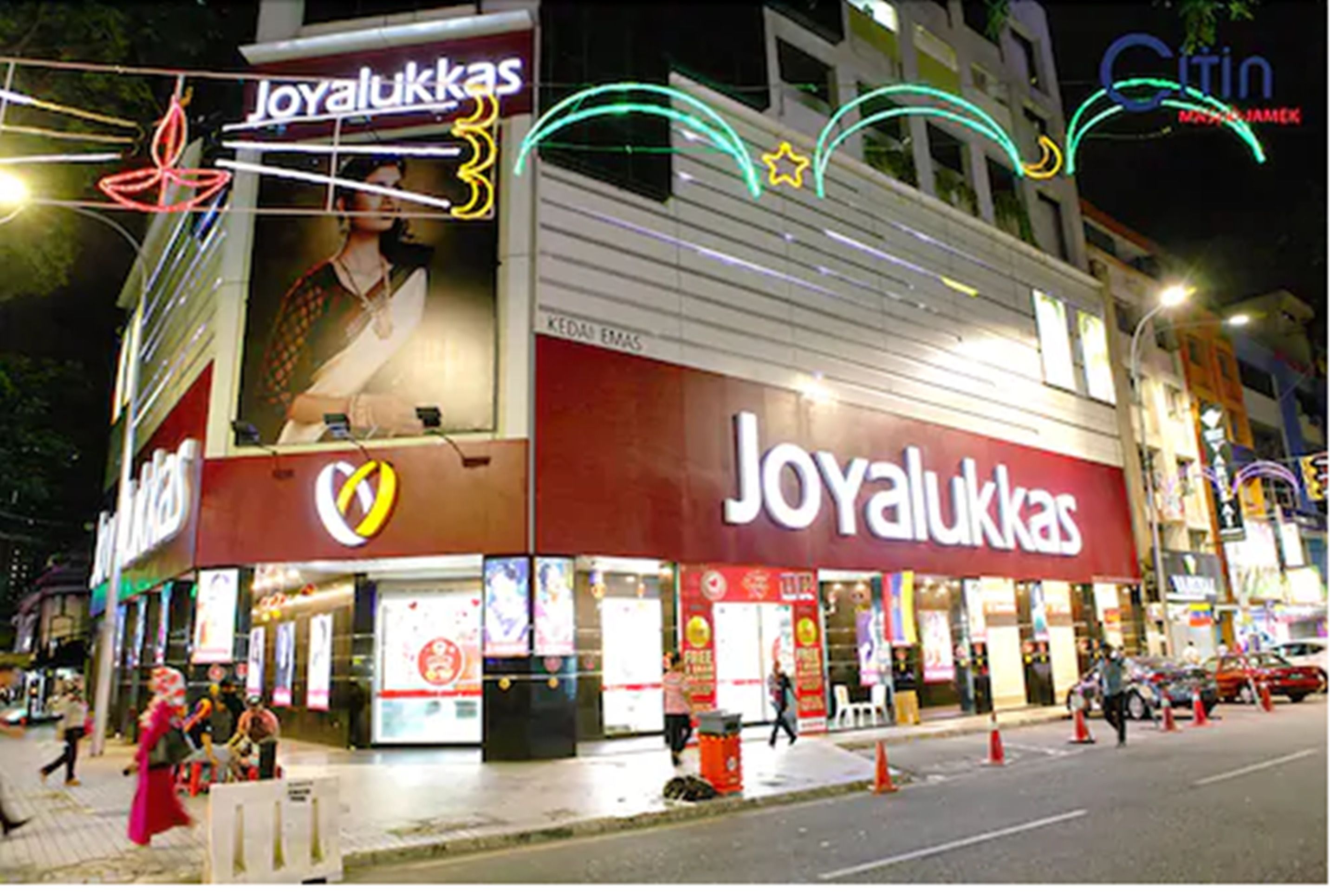 A shopping mall with a prominent 'Joyalukkas' store.