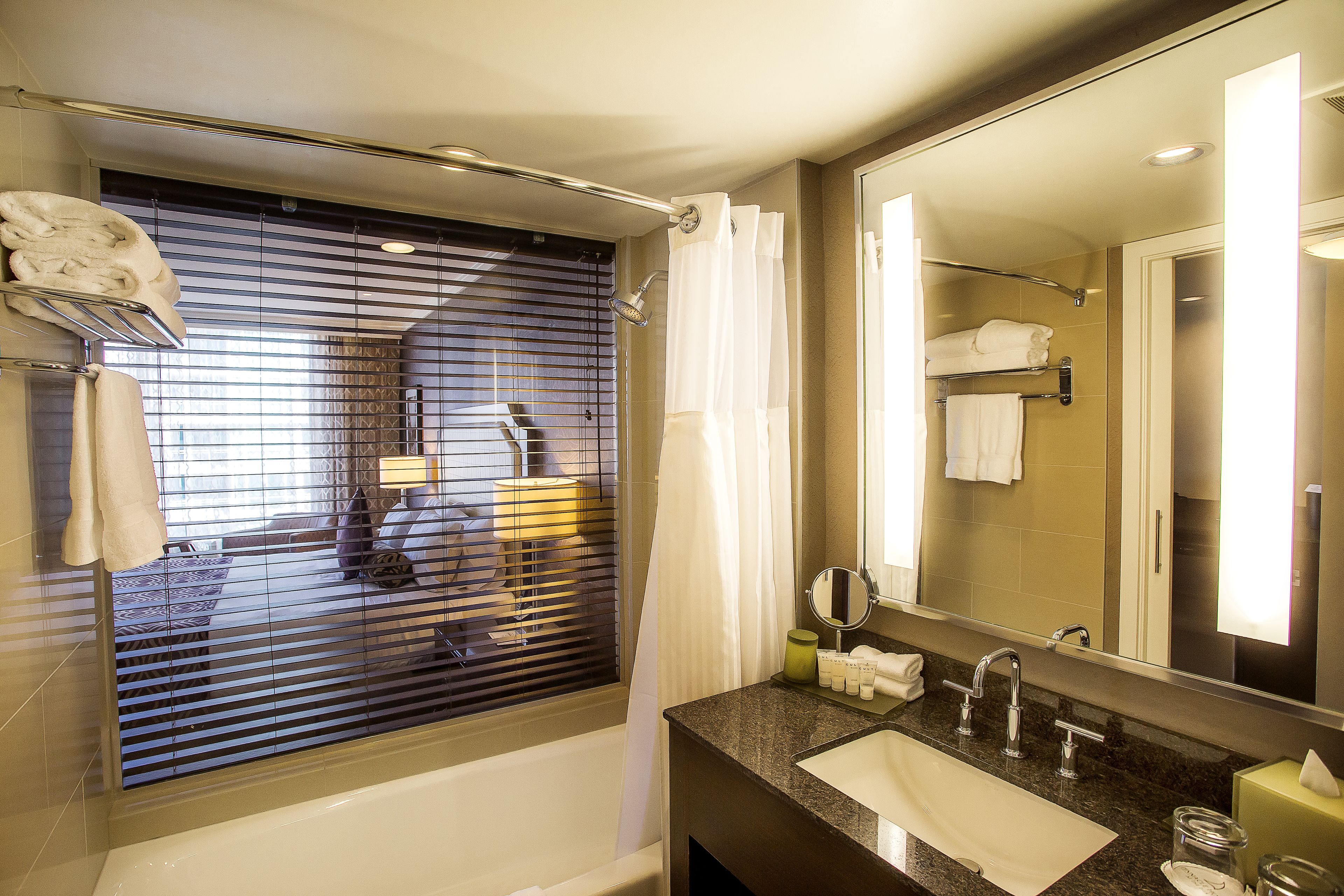 combined shower/bathtub, designer toiletries, hair dryer, bathrobes