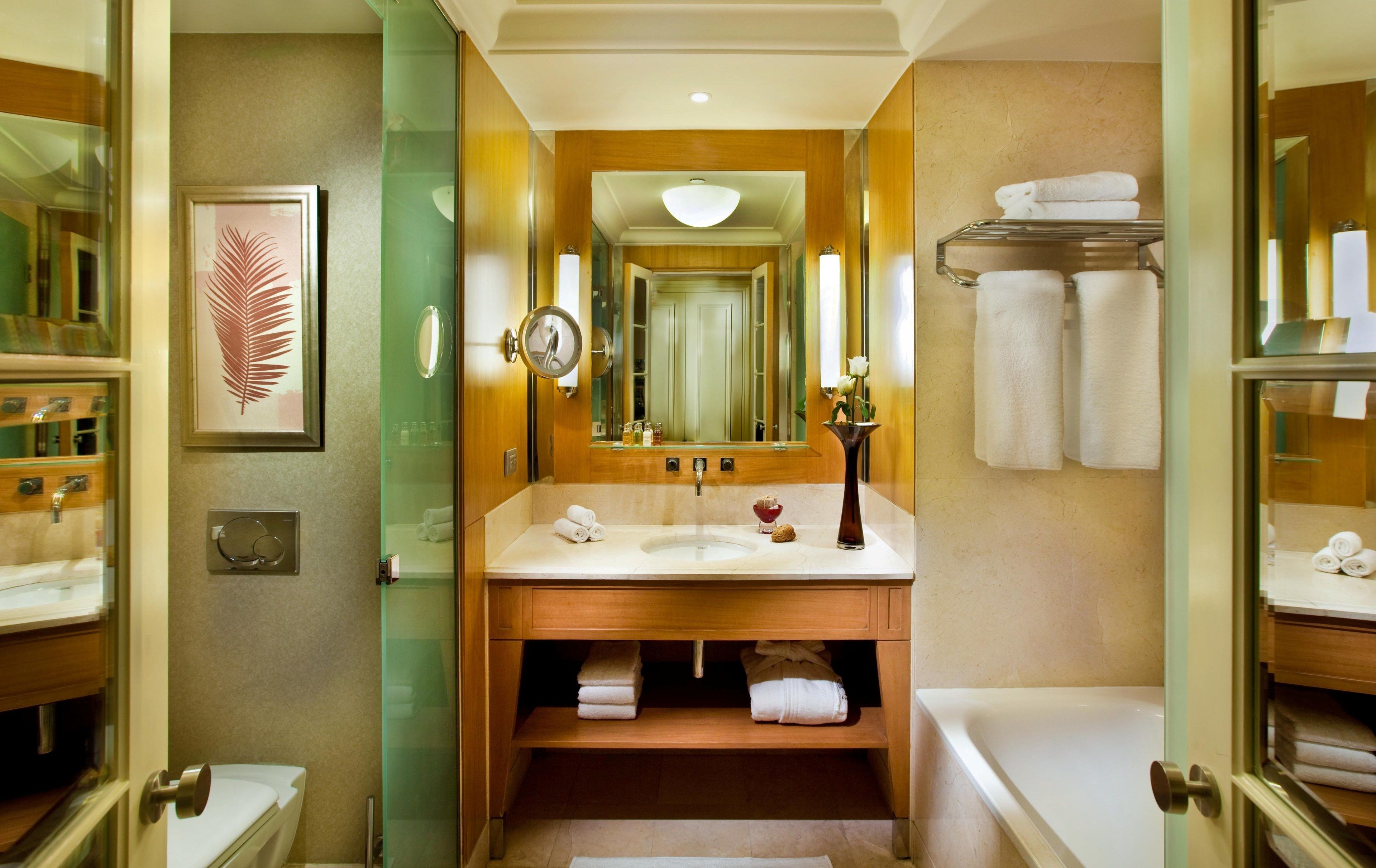 A bathroom with a sink, mirror, and towel rack.