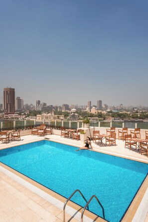 Outdoor pool, open 7:00 AM to 5:00 PM, pool umbrellas, sun loungers