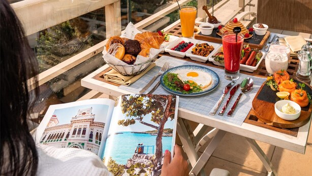 A dining table with breakfast items and a city view. - Kempinski Nile Hotel Cairo (Cairo)