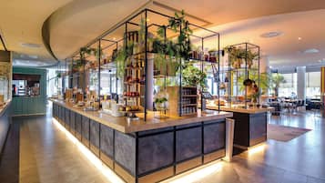 Enjoy a self-service dining experience in this stylish space with a central counter, seating, and kitchen area.