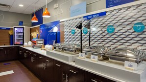 A breakfast buffet area with labeled food stations, a cereal refrigerator, and directional signs. - Holiday Inn Express Atlanta Airport West - Camp Creek Market by IHG (Atlanta)
