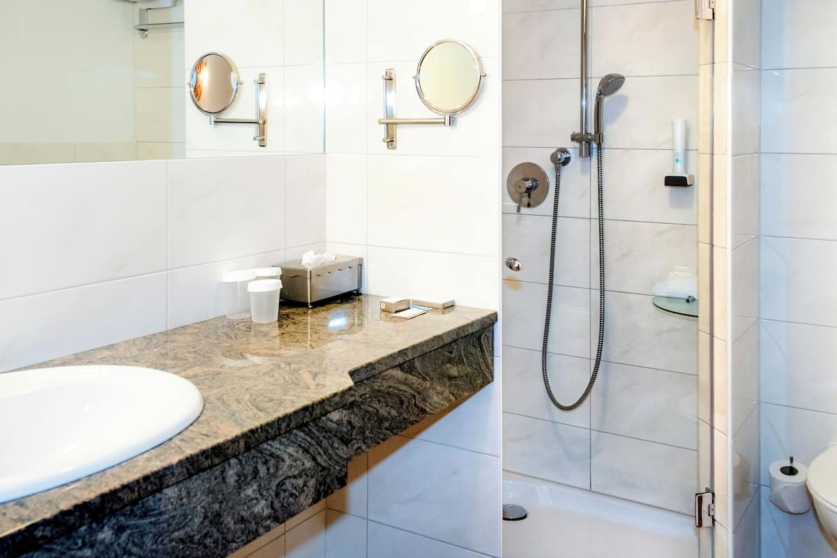 classic triple room, multiple beds | bathroom | eco-friendly toiletries, hair dryer, bathrobes, slippers