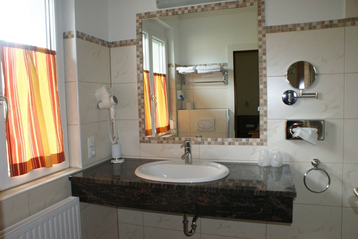 eco-friendly toiletries, hair dryer, bathrobes, slippers