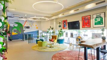 Un interior modern amb una zona de recepció, seients i objectes de col·lecció esportiva.
