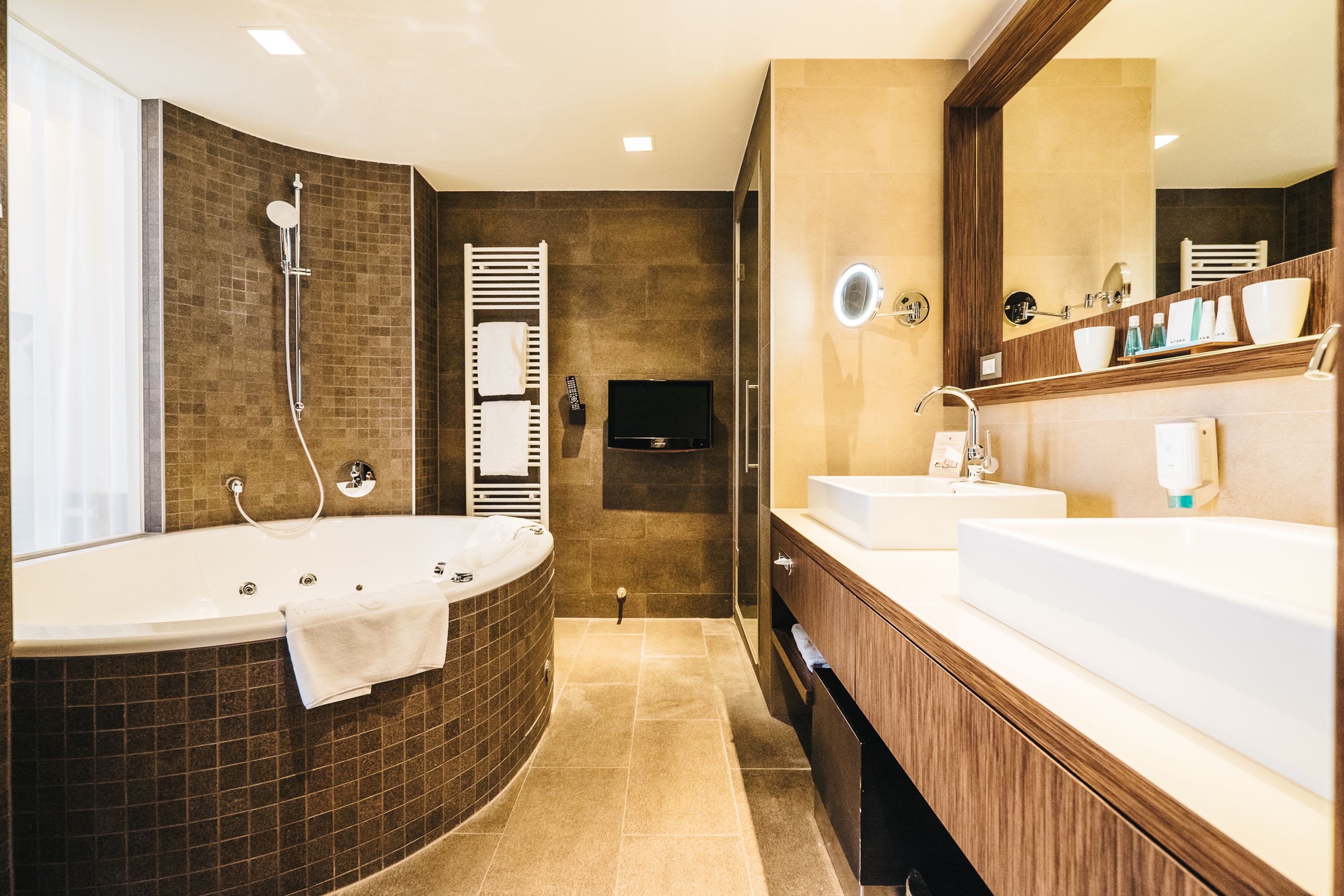 junior suite, lake view | bathroom | hair dryer, bathrobes, towels, soap