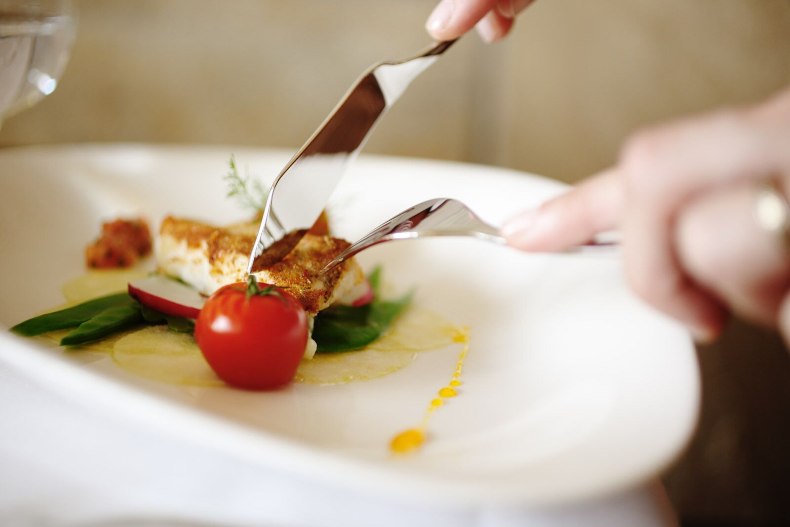 A close-up of a plated dish with a fork and knife.