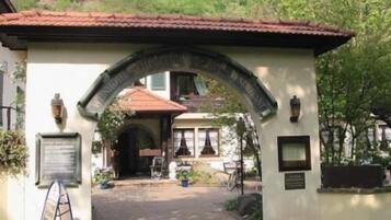 A building entrance with a tiled roof and an archway.