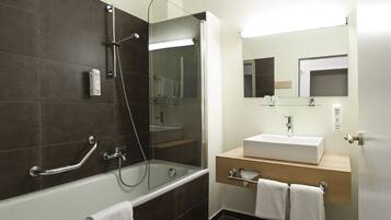 Combined shower/bathtub, hair dryer, slippers, towels