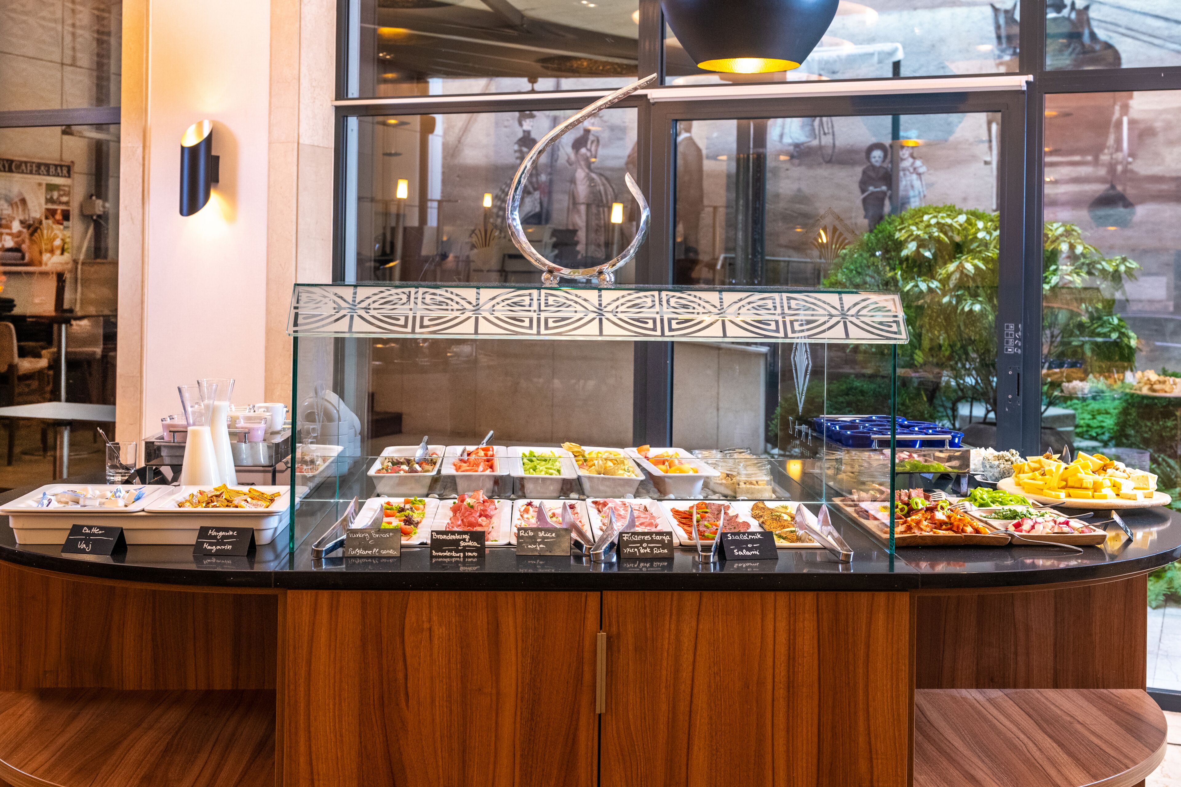 A buffet counter with various food options and a glass display case.