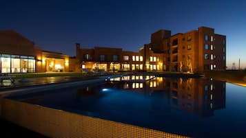 Guests can enjoy a refreshing swim in the hotel's pool surrounded by a spacious deck.