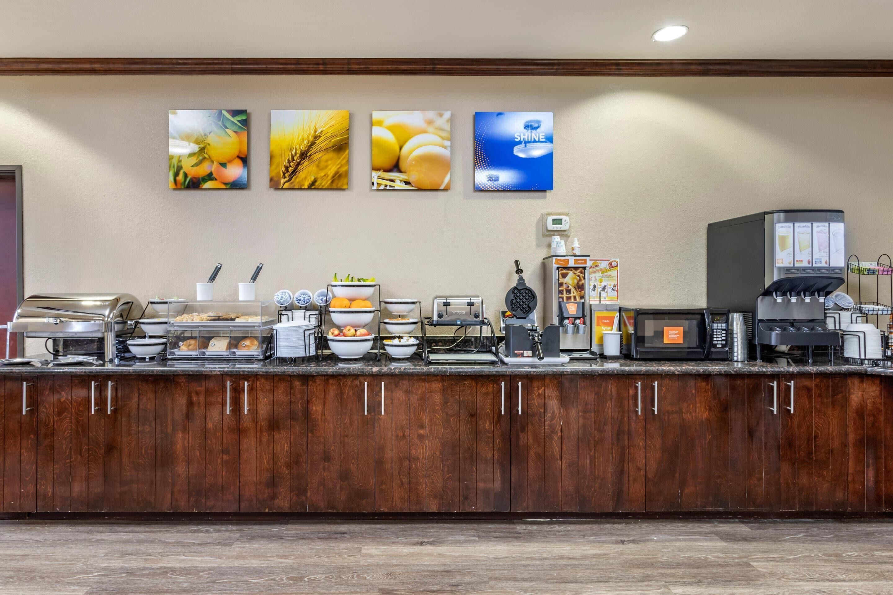A buffet setup with various food items and a coffee station.
