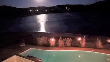 Relax by the illuminated pool surrounded by a serene ambiance.