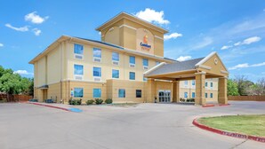 A large hotel with a central entrance, multiple windows, and a sign indicating it is a Comfort Suites hotel. - Comfort Suites Abilene Central (Abilene)