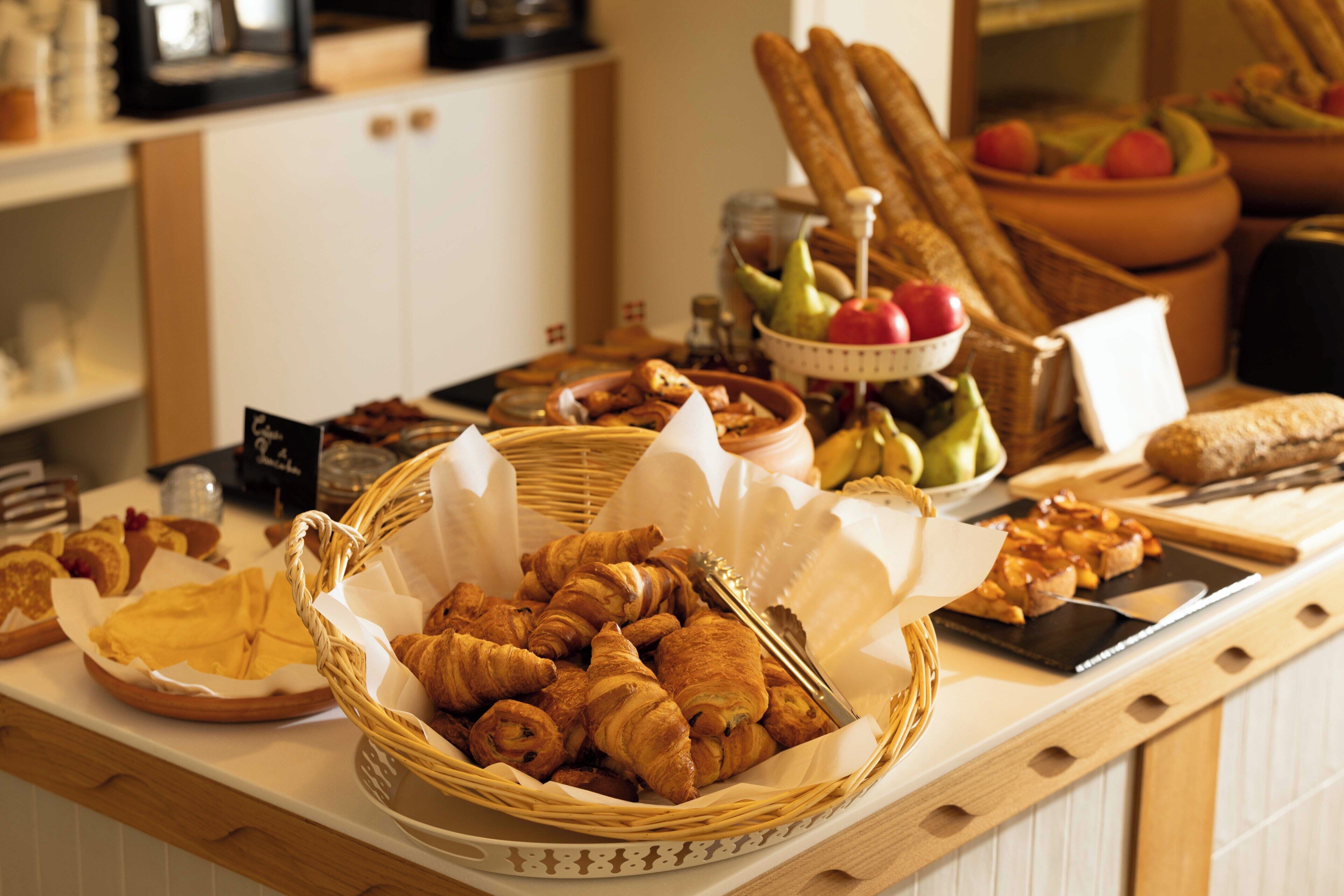 Ein Buffet mit verschiedenen Speisen, darunter Gebäck und Früchte.