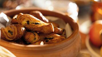 A clay bowl filled with pastries.
