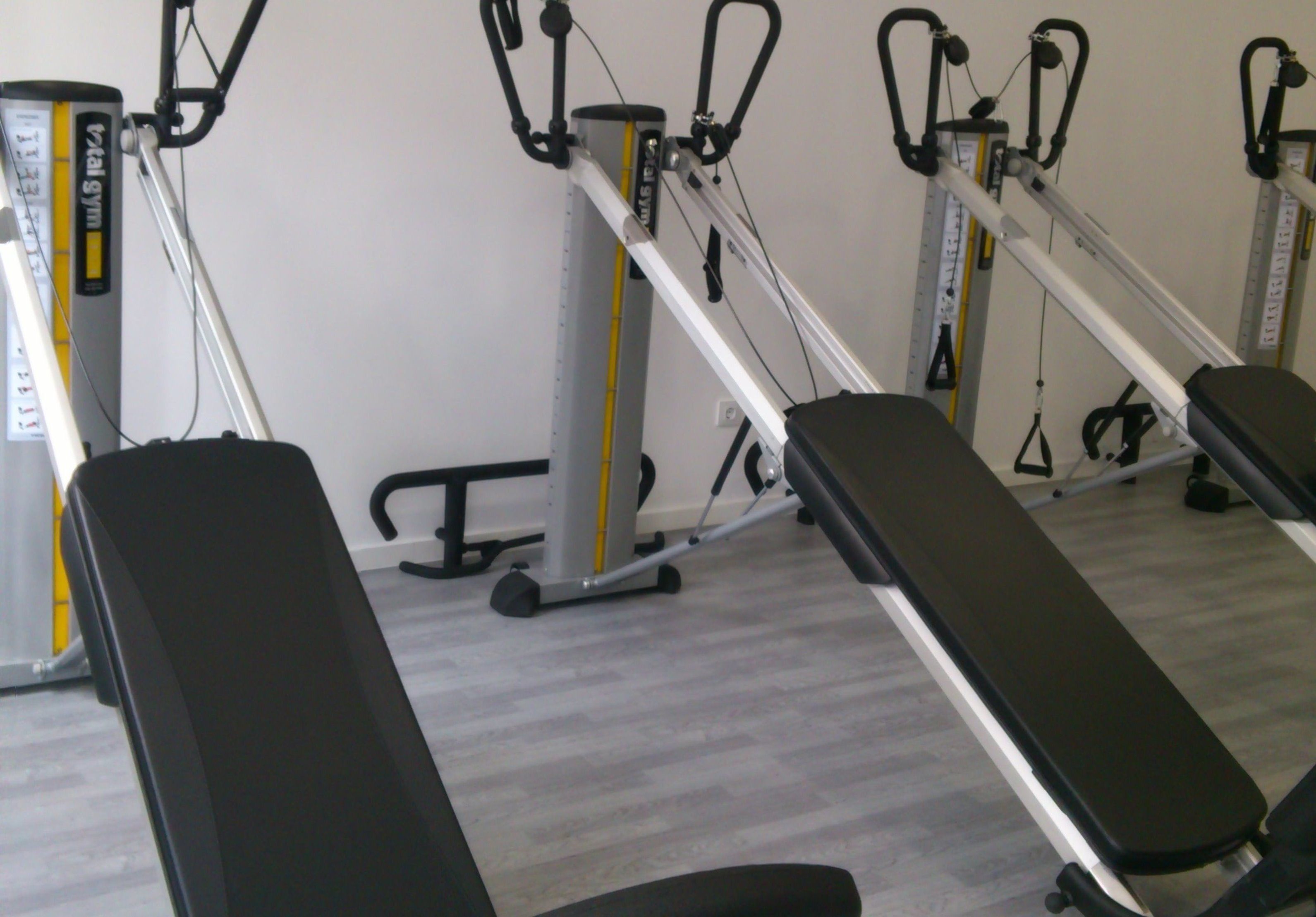 A gym with exercise equipment, including a bench and weight machines.