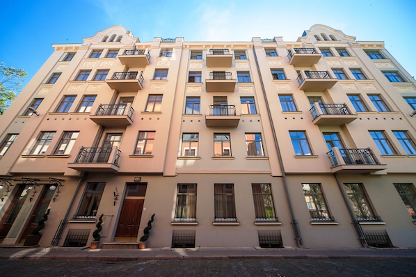 A multi-story building with balconies, large windows, and a classic architectural style.