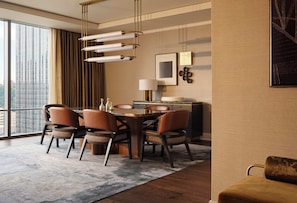 A modern dining area with a wooden table, leather chairs, and a city view through large windows. - Fairmont Pittsburgh (Pittsburgh)