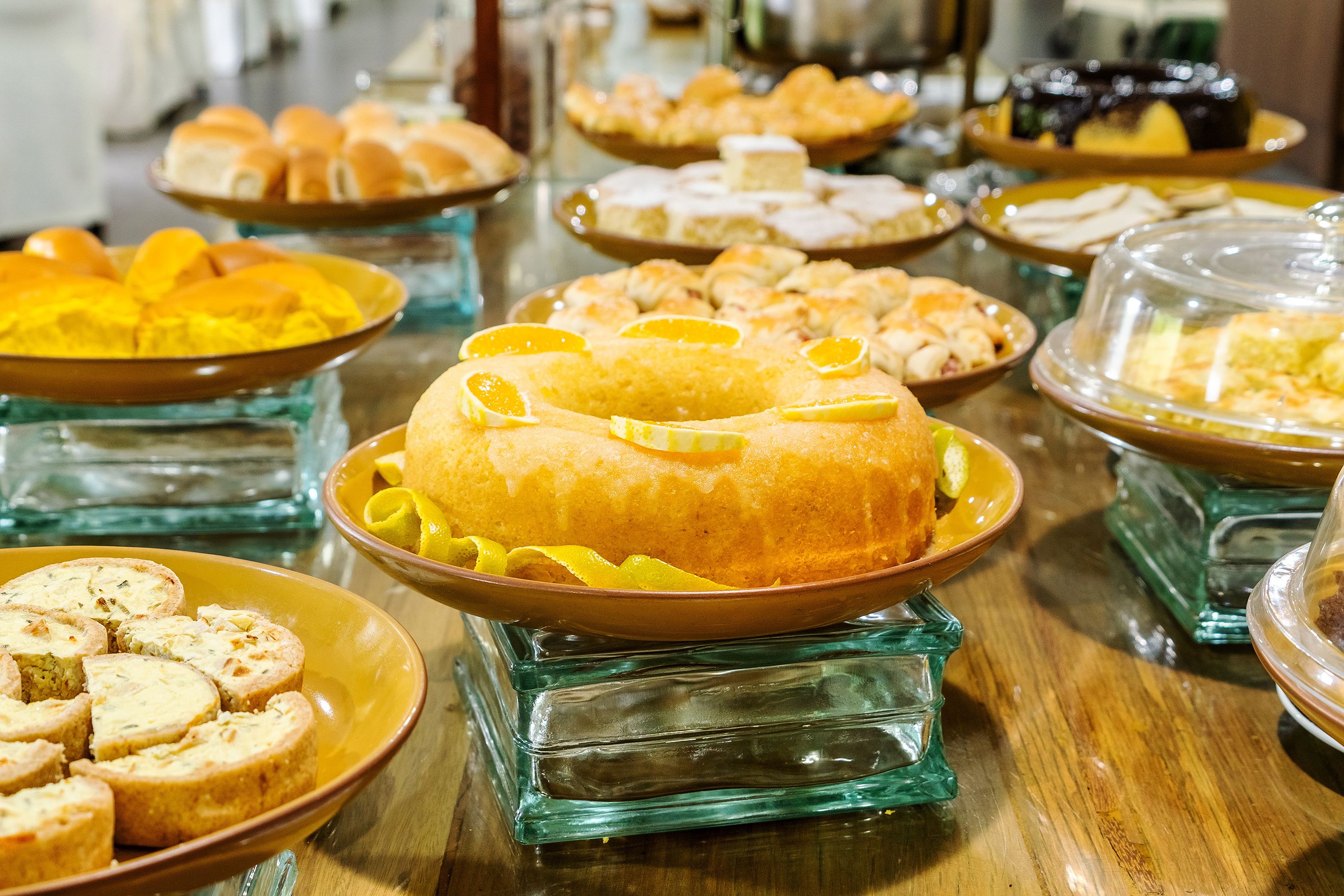 A buffet table with various dishes and desserts.