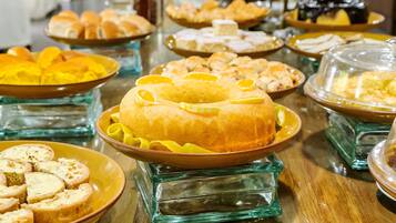 A buffet table with various dishes and desserts.