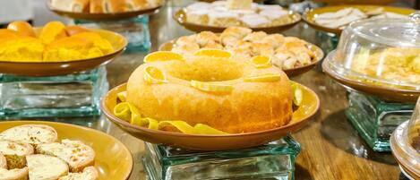 A buffet table with various dishes and desserts.