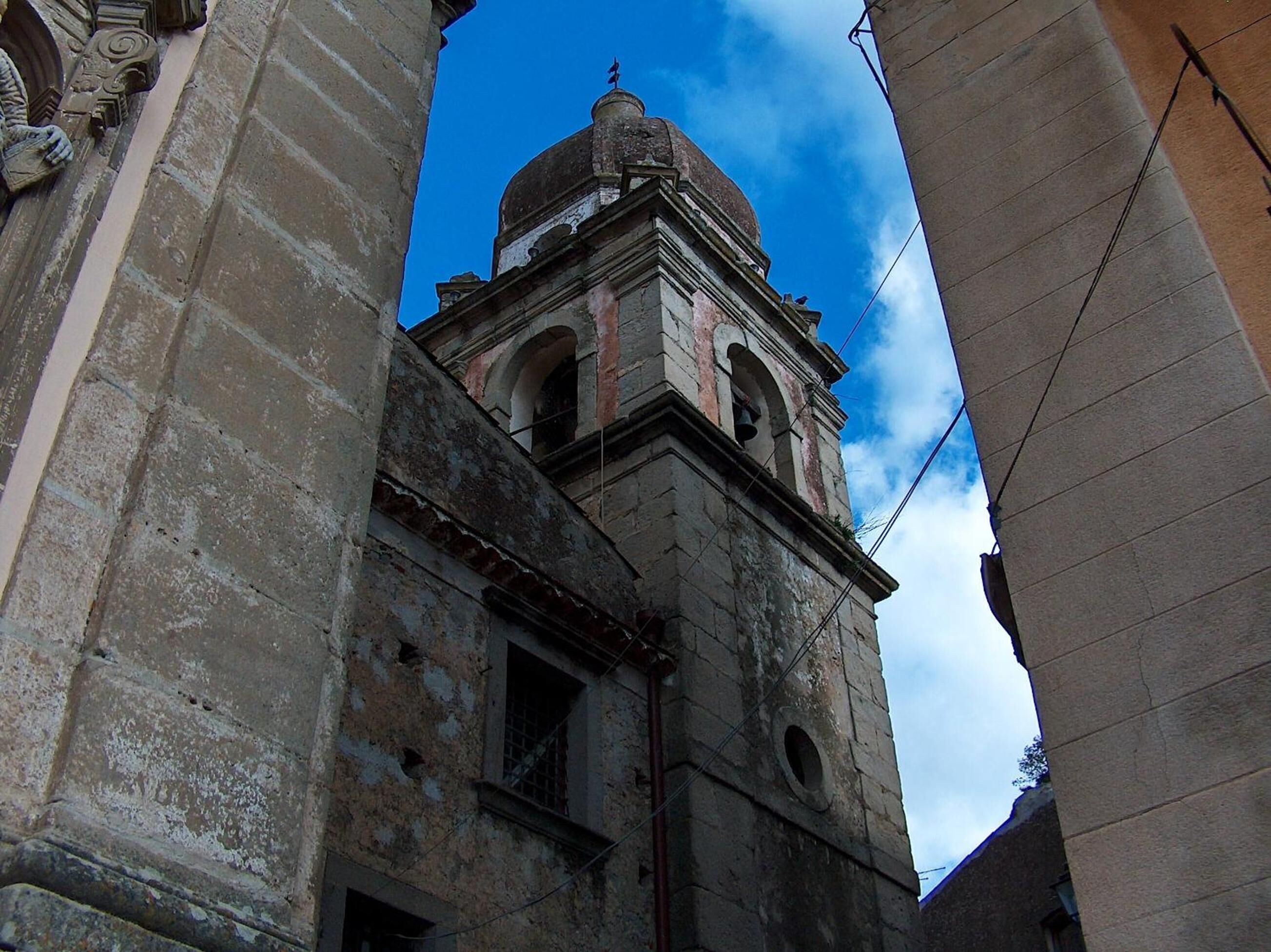 A historic building with a bell tower and arched windows.