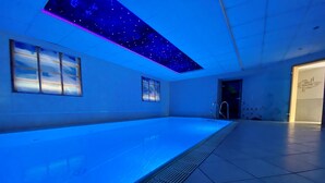 A swimming pool with a starry ceiling and a sauna sign. - Kleindienst (Ursensollen)
