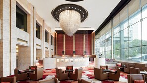 A modern lobby with a large chandelier, seating area, and a reception desk. - Suzhou Marriott Hotel (Suzhou)