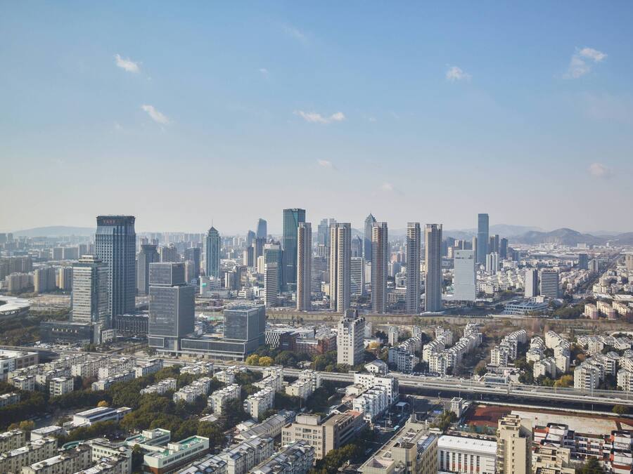 A cityscape with high-rise buildings, a river, and a bridge.
