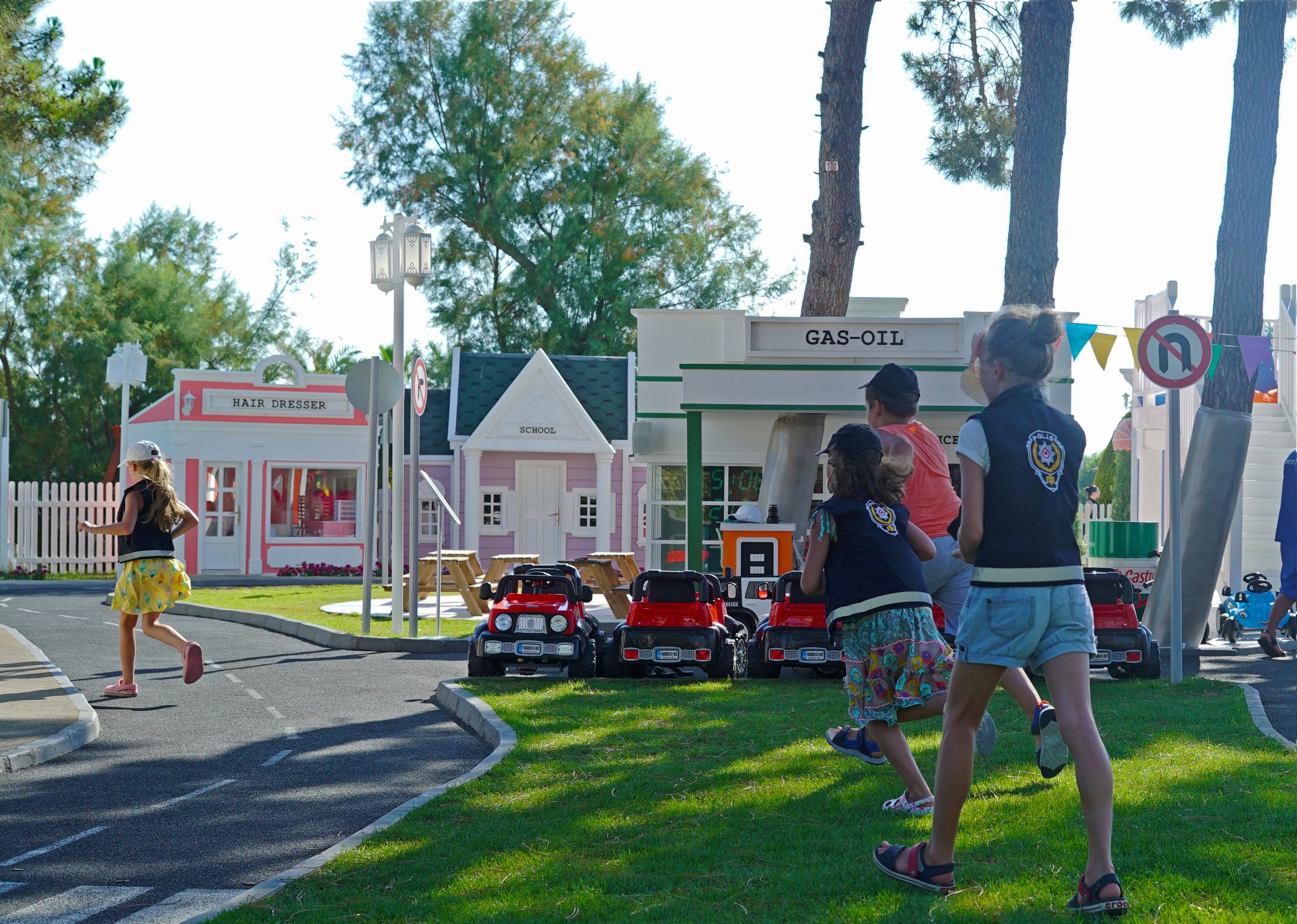 A children's play area with miniature buildings and toy cars.