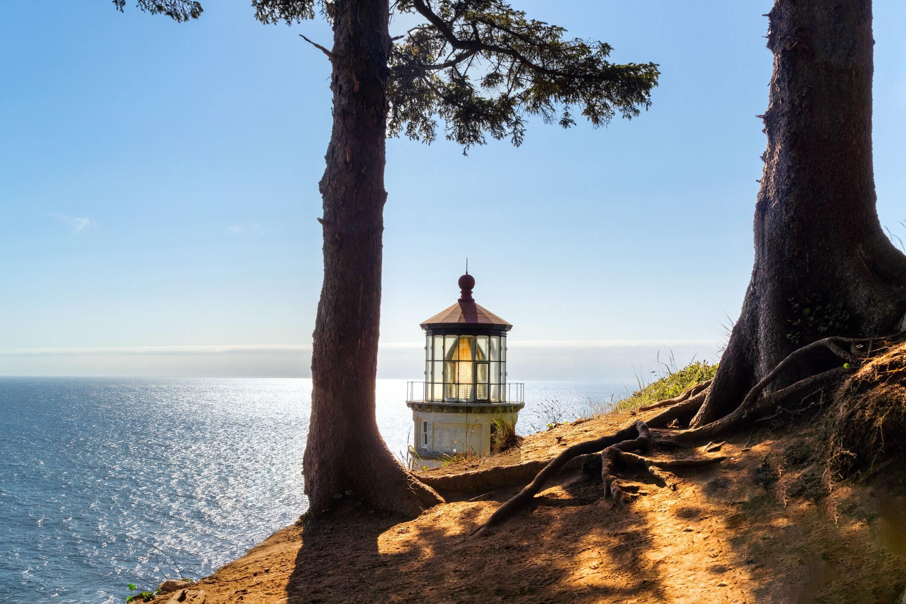 A lighthouse on a cliff overlooking the ocean.