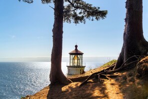 A lighthouse on a cliff overlooking the ocean. - Super 8 by Wyndham Florence OR (Florence)