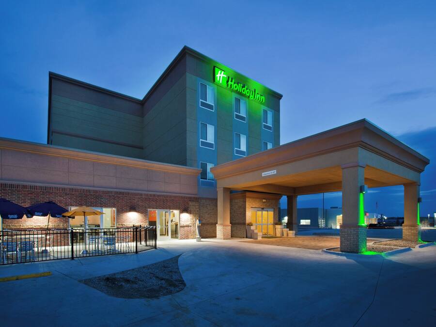 A Holiday Inn Express with a covered entrance and outdoor seating area.