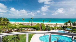 A resort with a pool, a beach view, and palm trees. - Grandview on Grace Bay (Providenciales)
