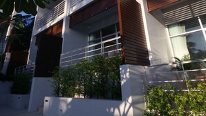 A modern multi-story building with balconies, large windows, and a clear sky. - The Park Samui (Koh Samui)