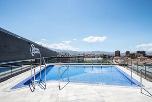Outdoor pool, open 11:00 AM to 7:00 PM, pool umbrellas, pool loungers