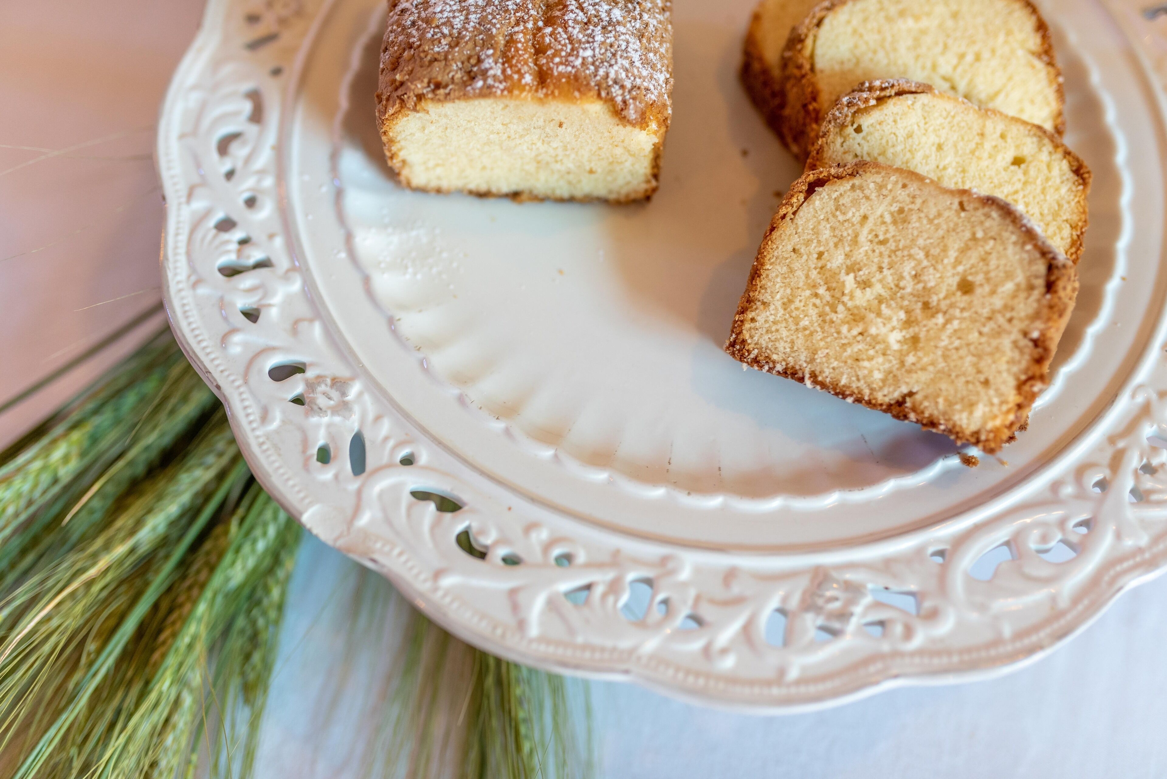 A white decorative plate with a slice of cake on it.