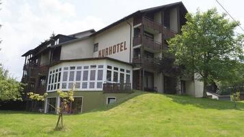 A multi-story building with the sign "Kurhotel" indicating it is a hotel.