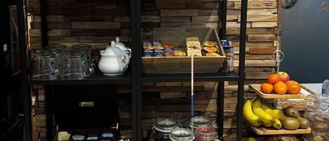 A café interior with wooden wall decor, a vintage poster, and a variety of tea and coffee products on shelves.