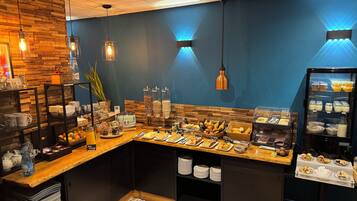 A breakfast buffet with various food items and a coffee station.