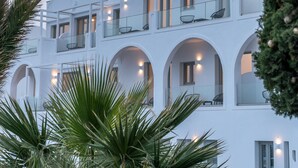 A multi-story building with balconies and arched windows. - Golden Star (Santorini)