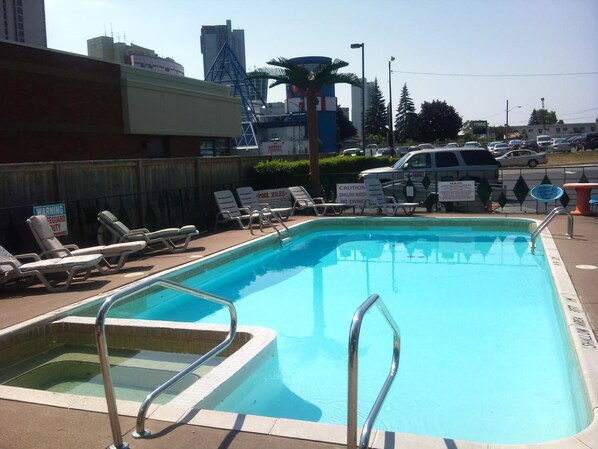 Seasonal outdoor pool, open 9:00 AM to 9:00 PM, pool loungers