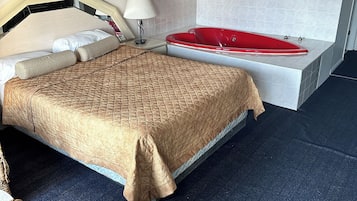 Deluxe Suite, 1 Queen Bed, Jetted Tub | 1 bedroom, desk, laptop workspace, blackout drapes