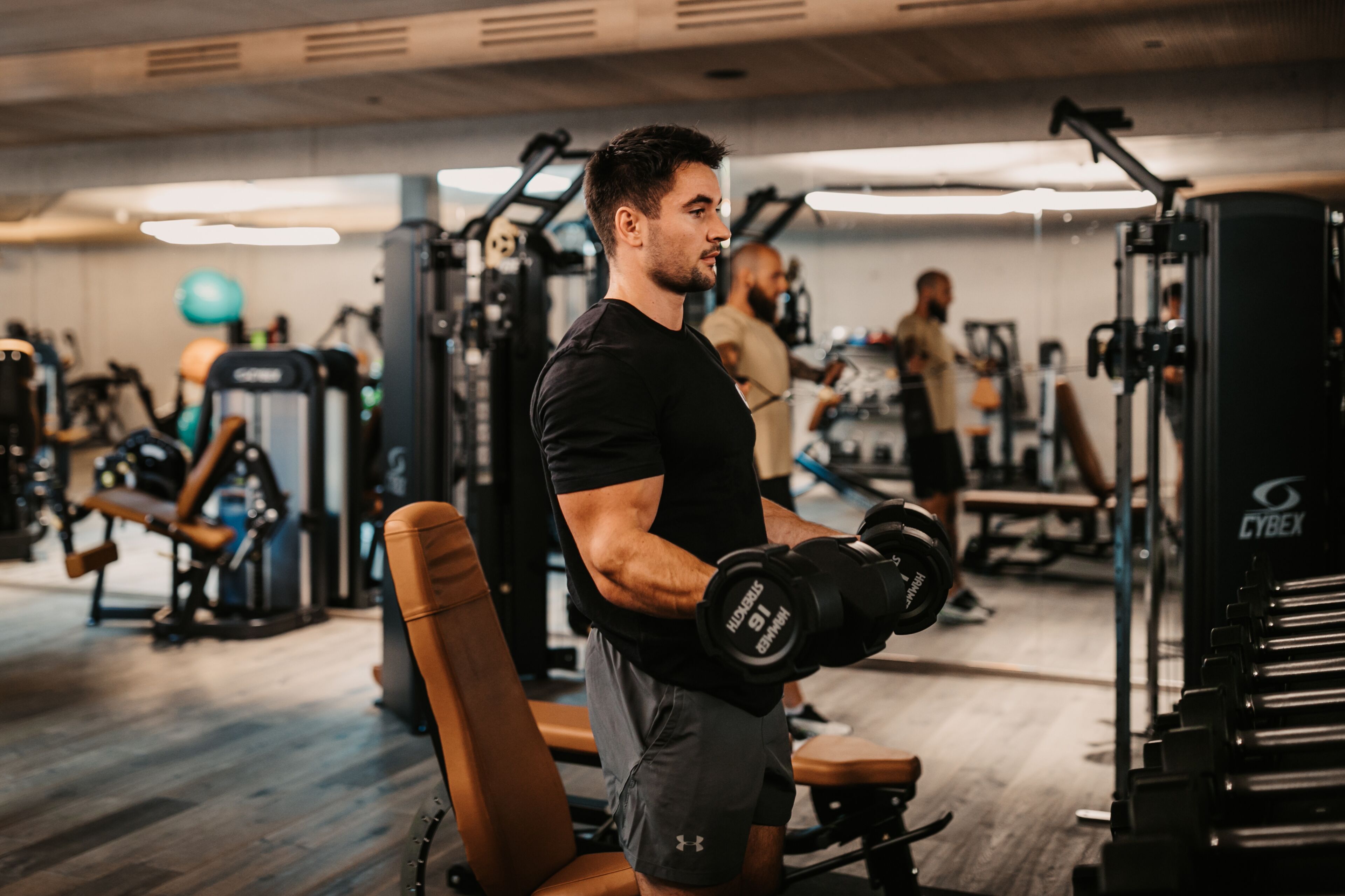A gym with various exercise equipment, including dumbbells and weight machines.