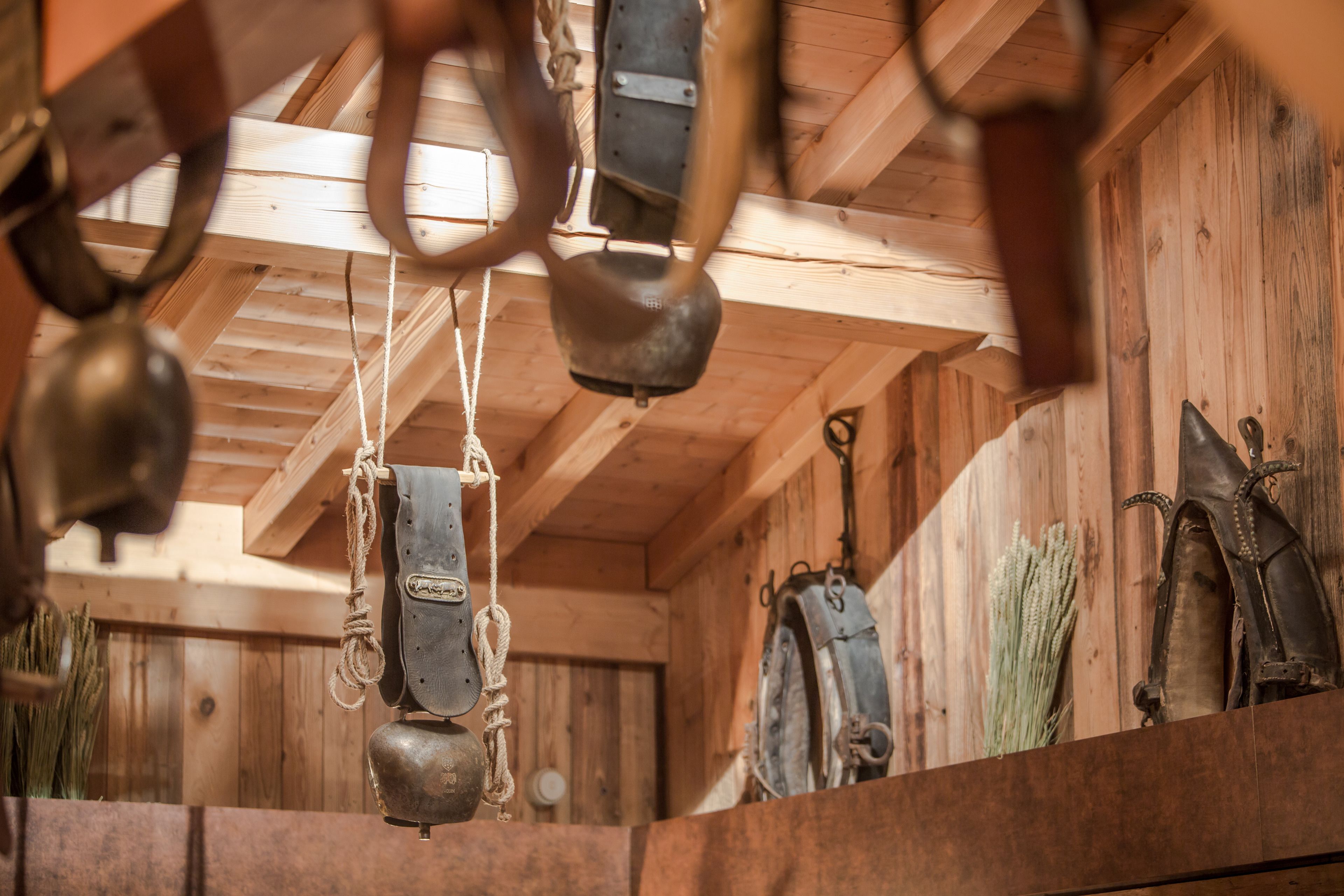 A rustic interior with wooden beams and a wooden wall.